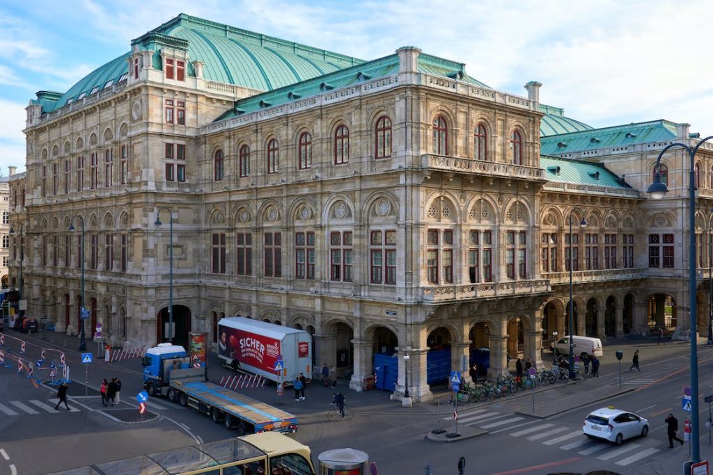 Επιβλητικό κτίριο στη Βιέννη με πράσινη οροφή και στο δρόμο αυτοκίνητα
